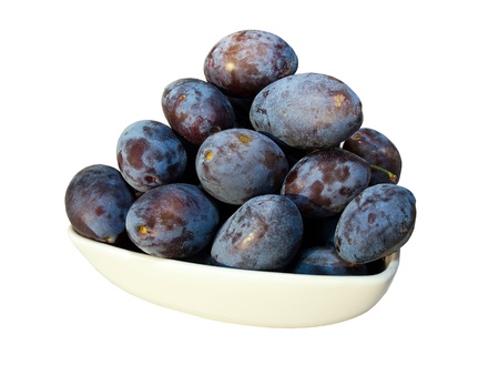 Fresh pulms in bowl isolated on white backgroundの写真素材