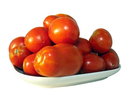 Red tomatoes on plate isolated on white backgroundの写真素材