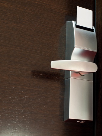 Closed door with white key cardの写真素材
