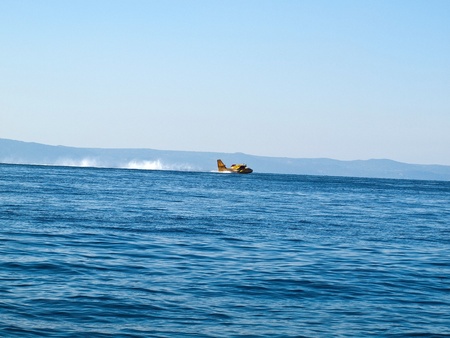 Fire fighter hidroplane landing at seaのeditorial素材