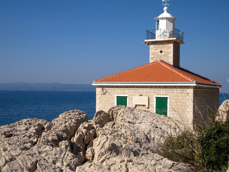 Stone mediterranean lighthouse near blue Adriatic seaのeditorial素材
