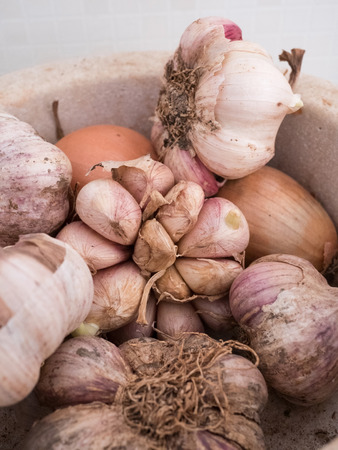 Organic garlic and onions in kitchenの写真素材