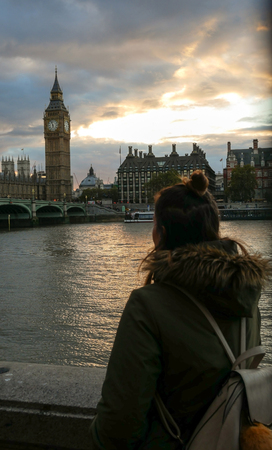 Woman watching Westminster palace and Big Ben at sunsetのeditorial素材