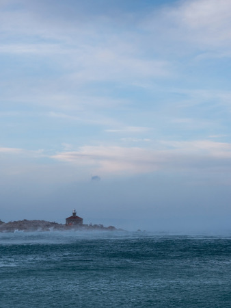 Lighthouse on sea storm and strong north windの写真素材