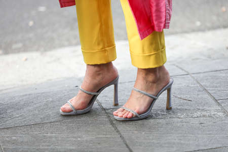 February 19, 2020: model wears yellow pants and a pair of silver shoes open with the heel during the Armani fashion show at the women`s fashion week fall / winter 2020 in Milanのeditorial素材