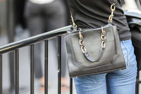 September 24, 2020: model is wearing a pair of jeans and a black leather handbagのeditorial素材