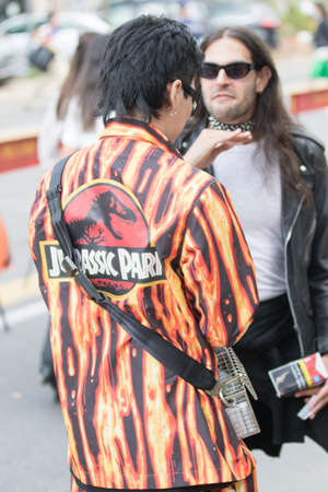 Model wears a colorful Jurassic park jacket