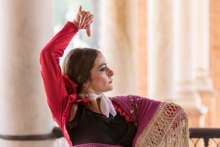 Seville, Spain - May 10, 2018: Dancer in traditional red dress dances flamenco, Sevilleのeditorial素材