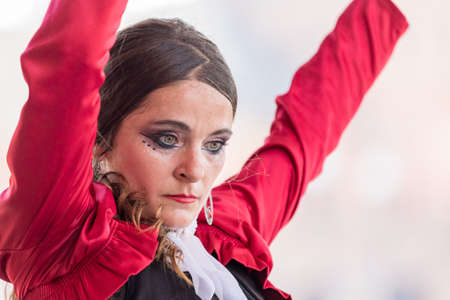 Seville, Spain - May 10, 2018: Dancer in traditional red dress dances flamenco, Sevilleのeditorial素材