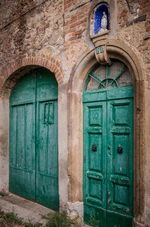 Green door at Toiano, little ghost town in Tuscany, Italyの写真素材