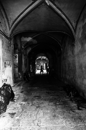 An old dark passage with the light coming from the arch. Lucca, Italyの写真素材
