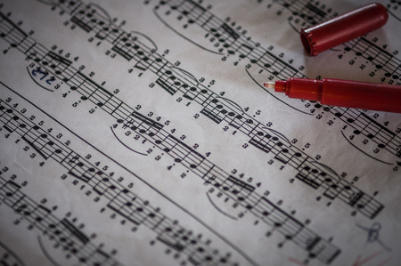 Close up of piano classic music score and notes and old paper with red pencilの写真素材