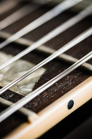 Close up image of electric guitar fingerboard