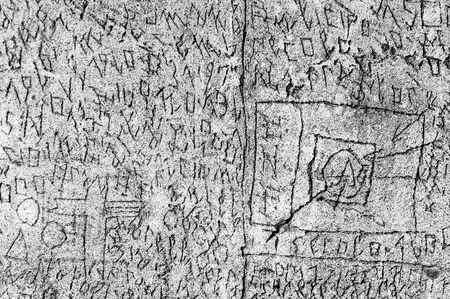 Volterra, Italy - September 2016: A mysterious series of runes, symbols and letters are scratched...