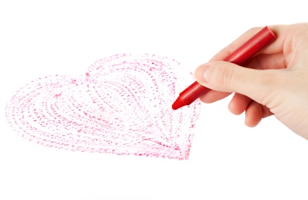 Hand with wax crayon drawing heartの写真素材