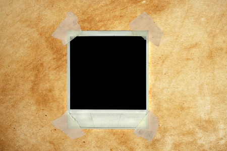Blank photo card with masking tape on abstract grunge backgroundの写真素材