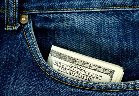 Blue jeans pocket with hundred dollars banknotesの写真素材