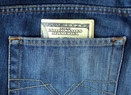Blue jeans pocket with hundred dollars banknotesの写真素材