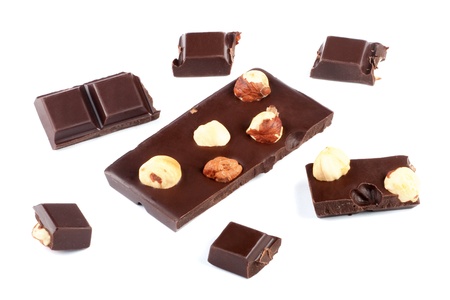 Pieces of milk chocolate bar with nuts isolated on whiteの写真素材
