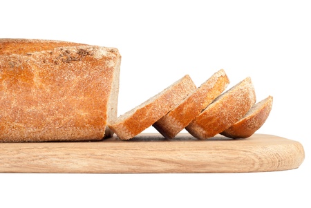 Sliced bread on a wooden chopping board isolated on whiteの写真素材