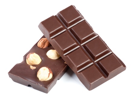 Pieces of milk chocolate bar with nuts isolated on whiteの写真素材