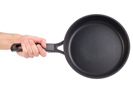 Frying pan in a hand isolated on white backgroundの写真素材