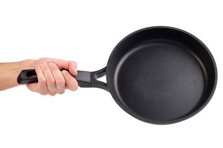 Frying pan in a hand isolated on white backgroundの写真素材