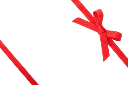 Red ribbon with a bow isolated on white backgroundの写真素材