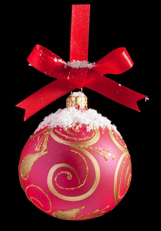 Red Christmas ball on a ribbon against black backgroundの写真素材