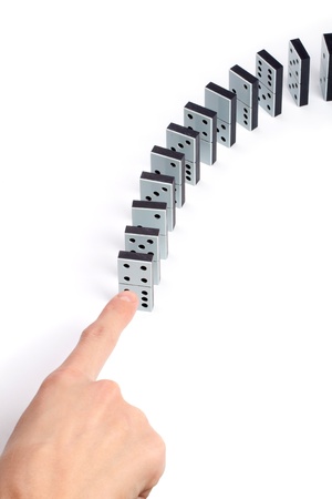 Hand pushing line of domino piecesの写真素材