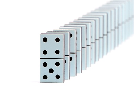 Domino pieces in a line on white backgroundの写真素材