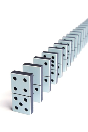 Domino pieces in a line on white backgroundの写真素材