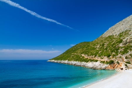 Beautiful sunny beach with white sand and blue waterの写真素材