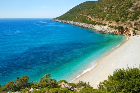 Beautiful sunny beach with white sand and blue waterの写真素材