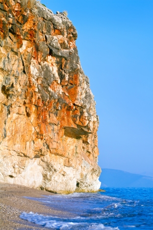 Rocky cliff above the beautiful sand beach at the Adriatic coastの写真素材