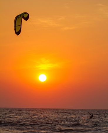 Silhouette of a kitesurfer st sunsetの写真素材