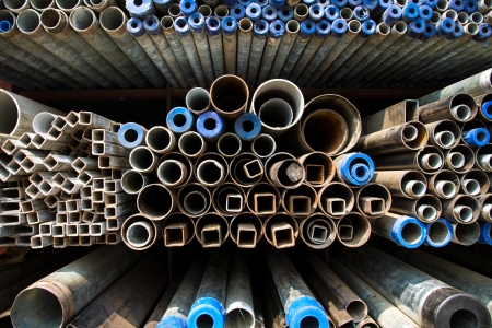 Stacked steel pipes and tubes backgroundの写真素材