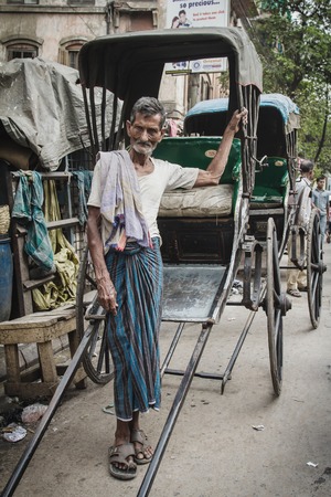 CALCUTTA - MARCH 13, 2013: rickshaw driver working on March 13, 2013 in Calcutta, India. Rickshaws...