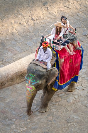 JAIPUR, INDIA - NOVEMBER 26: Tourists on an elephant ride tour near by the palace of the Amber Fort on November 26, 2012 in Jaipur, India.のeditorial素材