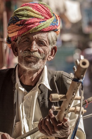 PUSHKAR, INDIA - DECEMBER 1: A Rajasthani man wearing traditional colorful turban posing after Pushkar Camel Fair on December 1, 2012 in Pushkar, Rajasthan, India.のeditorial素材