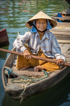 HOI AN, VIETNAM - MARCH 31: Woman driving the fishing boat in Hoi An, Vietnam on March 31, 2014.のeditorial素材