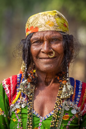 HAMPI, KARNATAKA, INDIA - FEBRUARY 1, 2013: Unidentified old Banjari woman wearing traditional dress poses for the camera in Hampi, Karnataka, India on February 1, 2013. Banjara people are nomadic people from the Indian state of Rajasthan.のeditorial素材