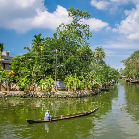KERALA, INDIA - FEBRUARY 17, 2013: Unidentified Indian man in his small boat in the backwaters of Kerala. The backwaters are the major tourist attraction in Kerala.のeditorial素材