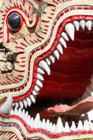 Dragon guard statue close up in the buddhist temple in Thailandの写真素材