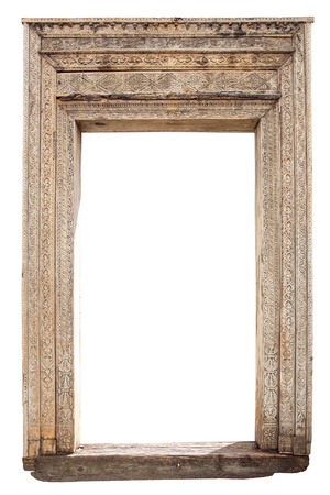 Old weathered carved wooden door frame isolated on whiteの写真素材