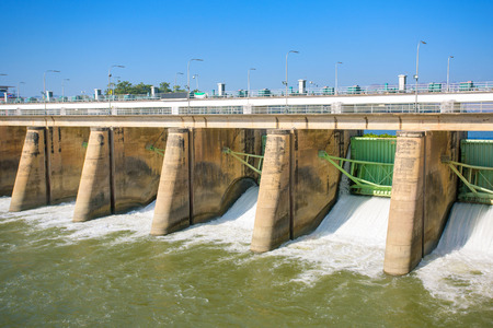 Water rushing through gates at a dam in Kanchanaburi provinceの写真素材