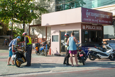 Phuket, Thailand - February 3, 2015: Road police check tourists on motorbike in Patong, Phuket, Thailandのeditorial素材