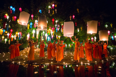 Chiang Mai, Thailand - November 6, 2014: Loy Kratong Festival, Buddhist monk fire candles to the Buddha and floating lamp on November 6, 2014 in Phan Tao Temple, Chiangmai, Thailand.のeditorial素材