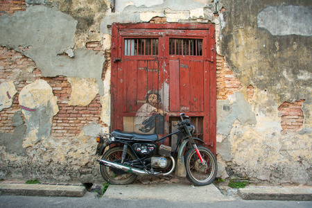 Georgetown, Penang, Malaysia - February 23, 2015: "Boy on a Bike" street art mural by Lithuanian artist Ernest Zacharevic in George Town, Penang, Malaysia.のeditorial素材