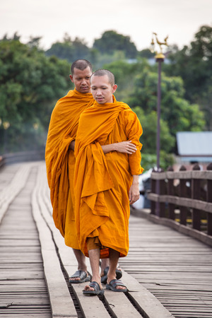 Sangkhlaburi, Kanchanaburi, Thailand - January  12, 2015: Buddhist monks walk on Bamboo Bridge the Sangkhlaburi River, Kanchanaburi, Thailand.のeditorial素材